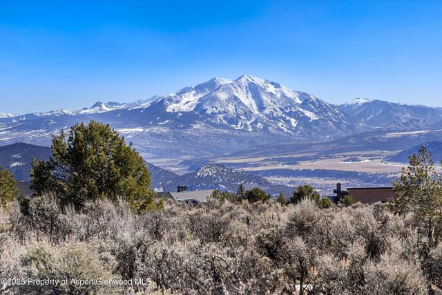 a view of a large building with a mountain in the background