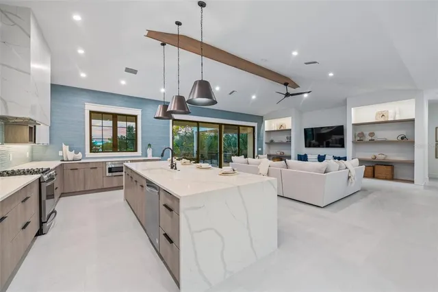 a view of a dining room with furniture and chandelier