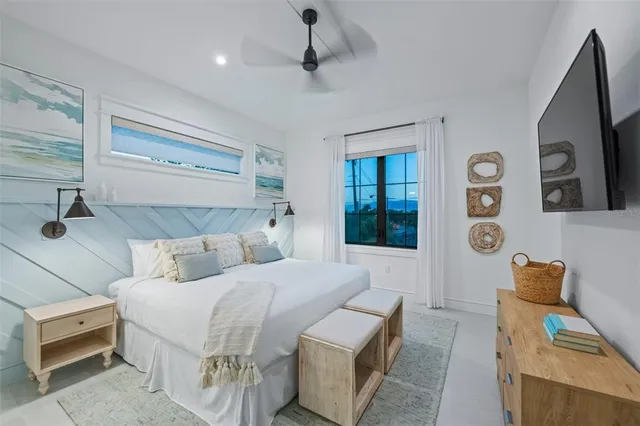 a bedroom with a large bed and a chandelier