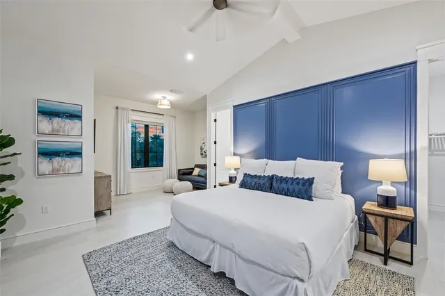 a bedroom with a bed and a large window