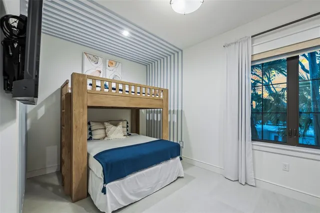 a hallway with a large window and a fireplace