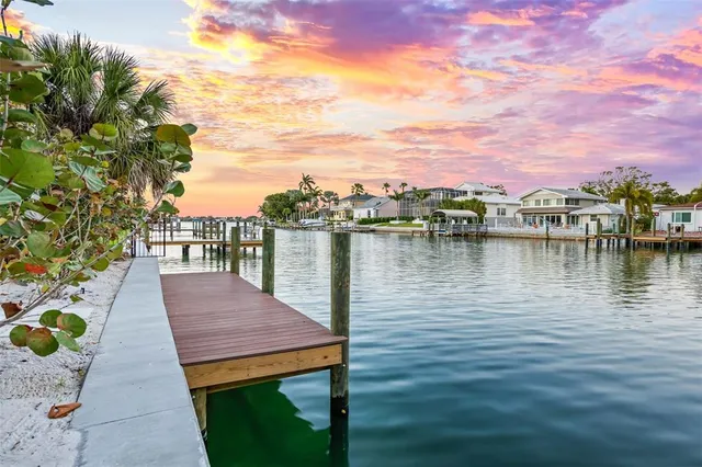 a view of a balcony with chairs and a potted plant