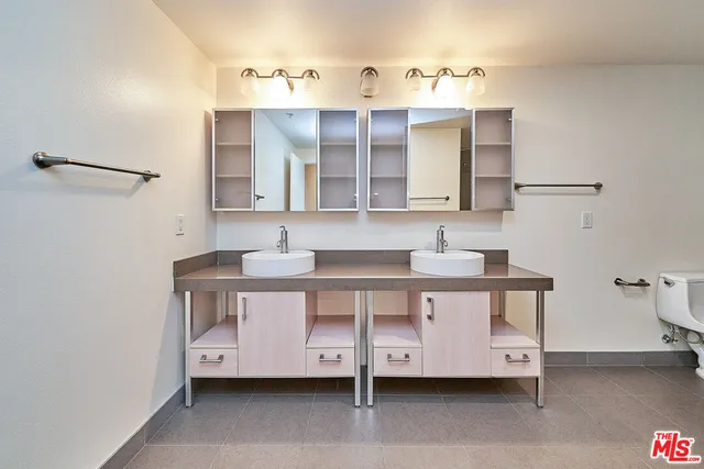 a bathroom with a double vanity sink and a mirror
