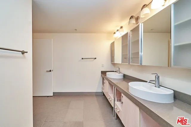 a bathroom with a double vanity sink and mirror
