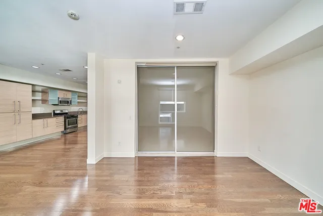 a view of a kitchen with a sink and a refrigerator