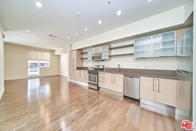 a kitchen with stainless steel appliances granite countertop a refrigerator and cabinets