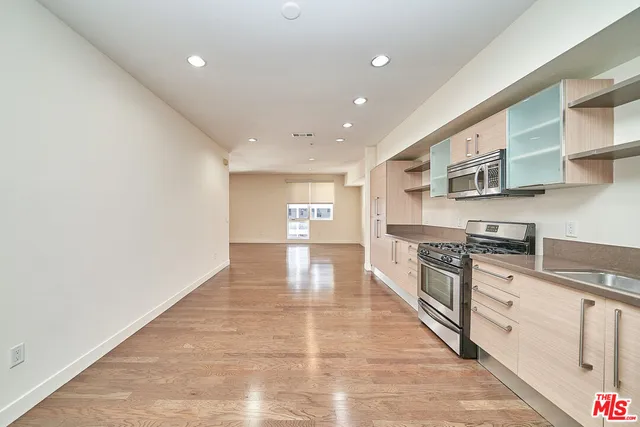 a kitchen with stainless steel appliances granite countertop a stove and a sink