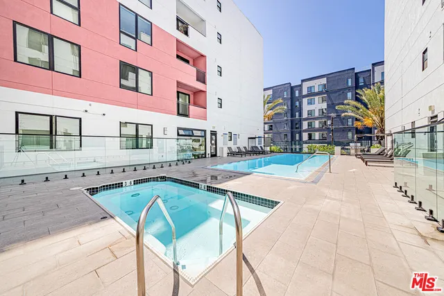 a swimming pool with outdoor seating and yard
