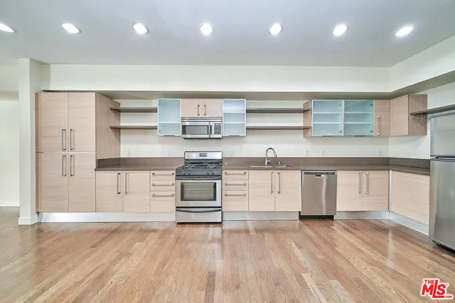 a kitchen with stainless steel appliances a stove and cabinets
