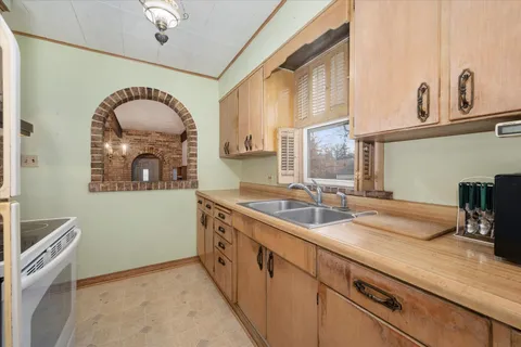 a bathroom with a sink a mirror and a window