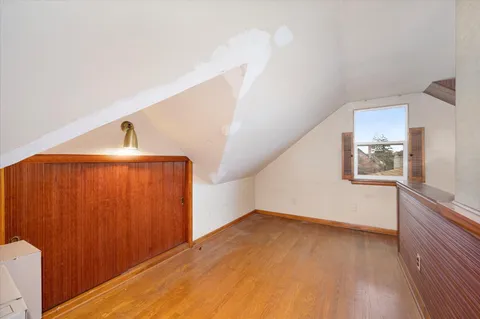 a view of a room with wooden floor and staircase