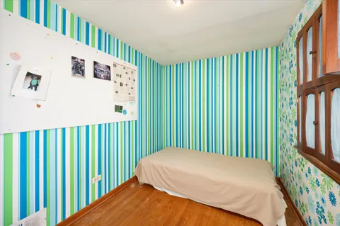 a bedroom with a bed and a book shelf