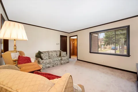a living room with furniture and a lamp