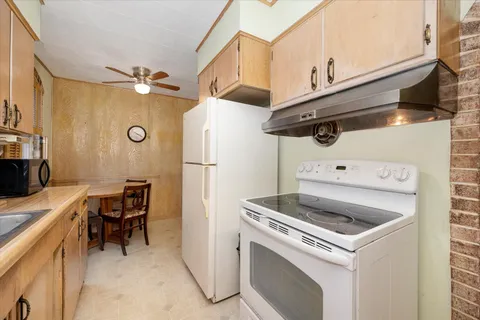 a kitchen with a refrigerator and a stove
