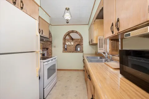 a kitchen with stainless steel appliances a refrigerator and a stove