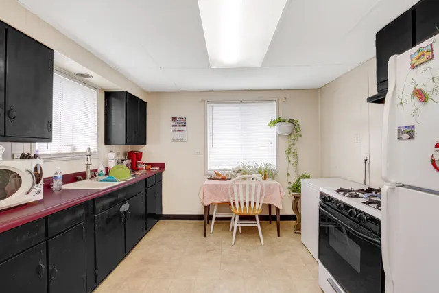 a kitchen with a sink stove and cabinets