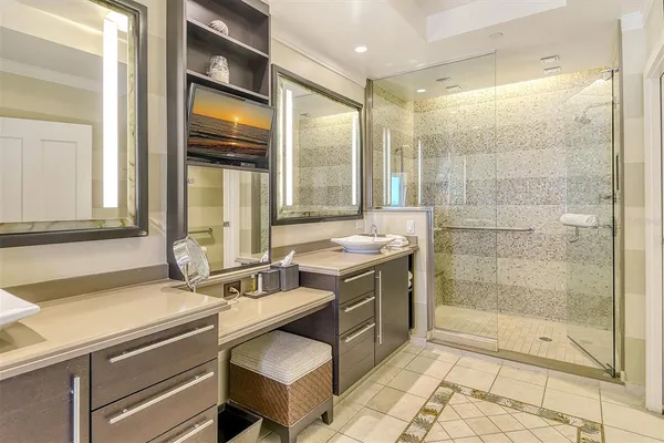 a bathroom with a sink mirror and a shower