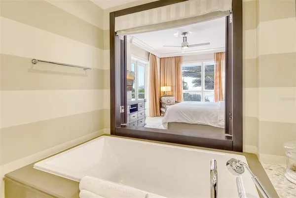 a bathroom with a bathtub and next to a window