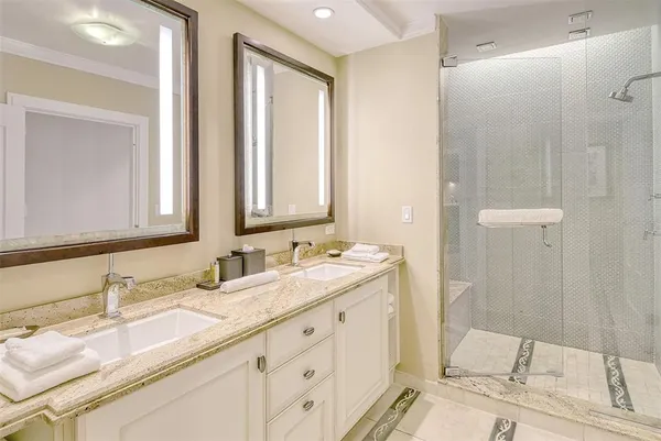 a bathroom with double sink and a mirror