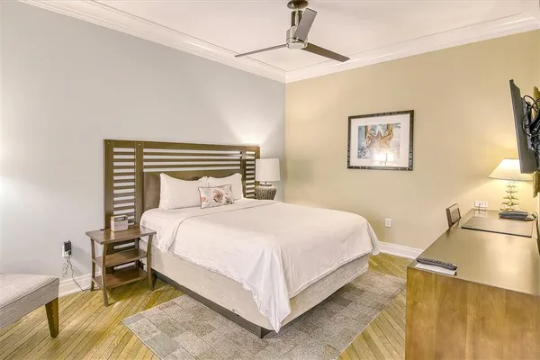 a bedroom with a bed and painting on the wall