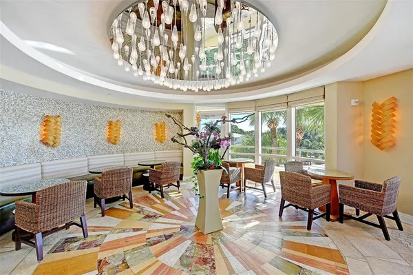 a view of a dining room with furniture a chandelier and wooden floor
