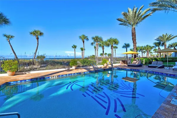 a view of a swimming pool with a table and chairs