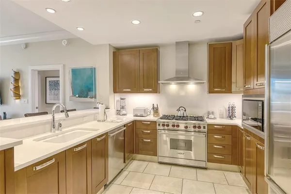 a kitchen with a stove sink and cabinets