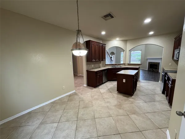 a view of a kitchen with a sink and cabinets