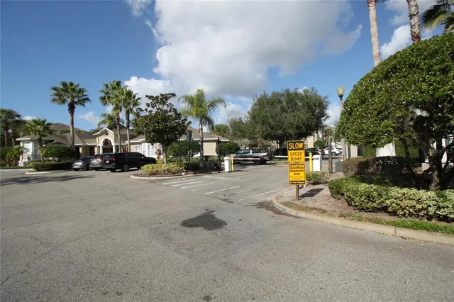 a view of road with card parked on side and road