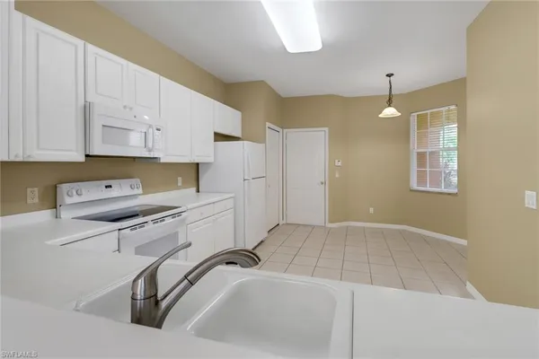 a kitchen that has a sink and a stove in it