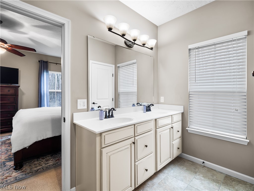 8898 Harvest Ridge Way North Ridgeville, OH 44039 - Photo 17 of 41 Ensuite bathroom with double vanity and ceiling fan