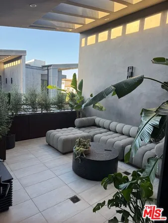 a living room with furniture and a floor to ceiling window
