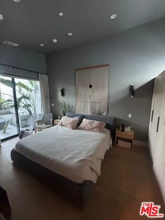a bed room with a bed and a large window
