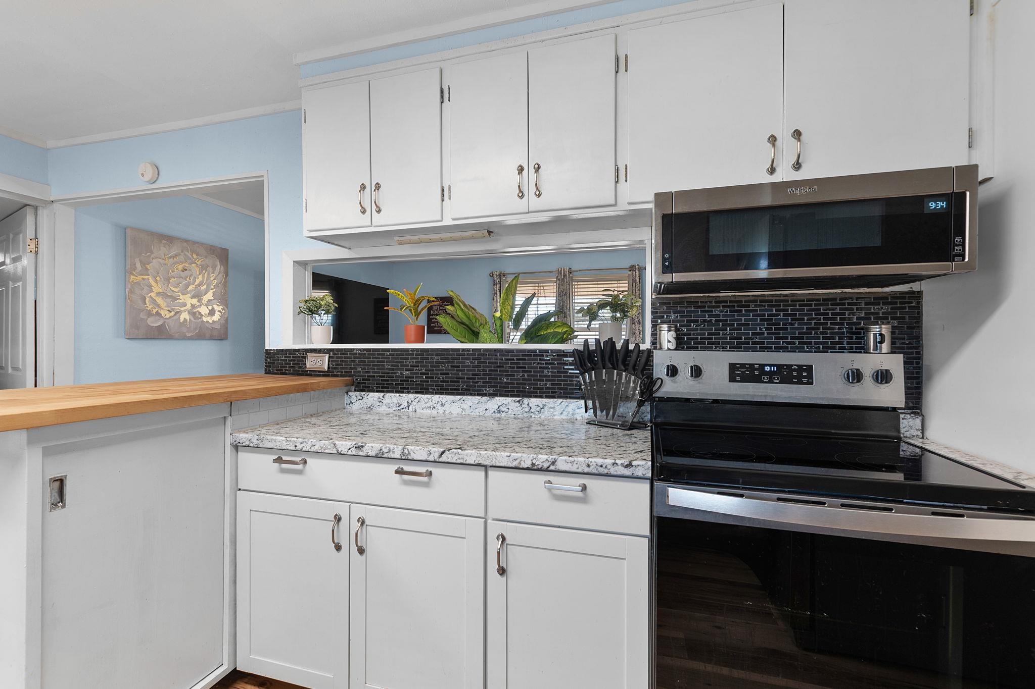 1365 Norma Tow, TX 78672 - Photo 20 of 45 a kitchen with granite countertop a stove and a sink