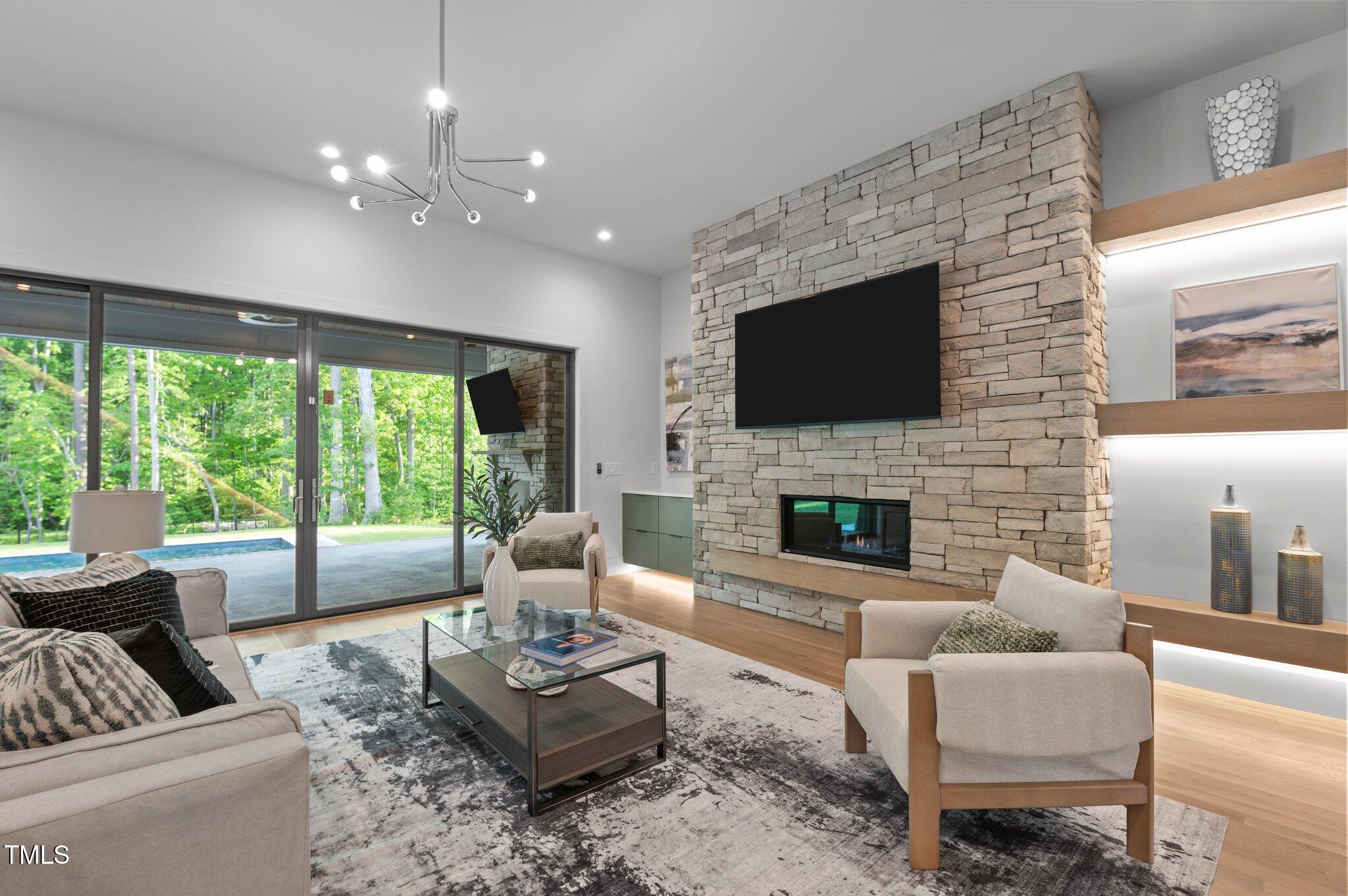 949 Harrison Ridge Road Wake Forest, NC 27587 - Photo 11 of 52 a living room with furniture a large window and a fireplace