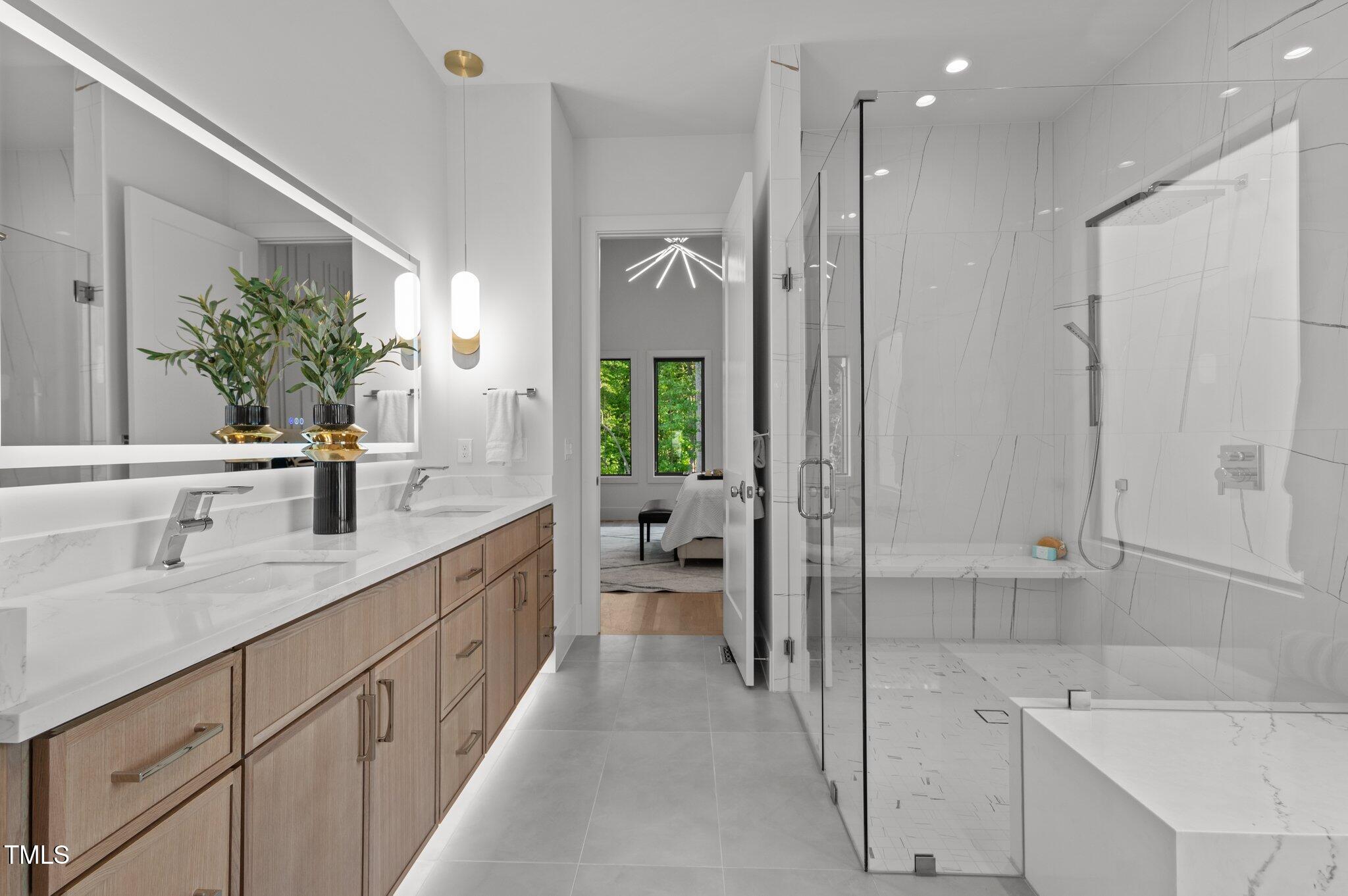 949 Harrison Ridge Road Wake Forest, NC 27587 - Photo 16 of 52 a bathroom with a sink and a large mirror
