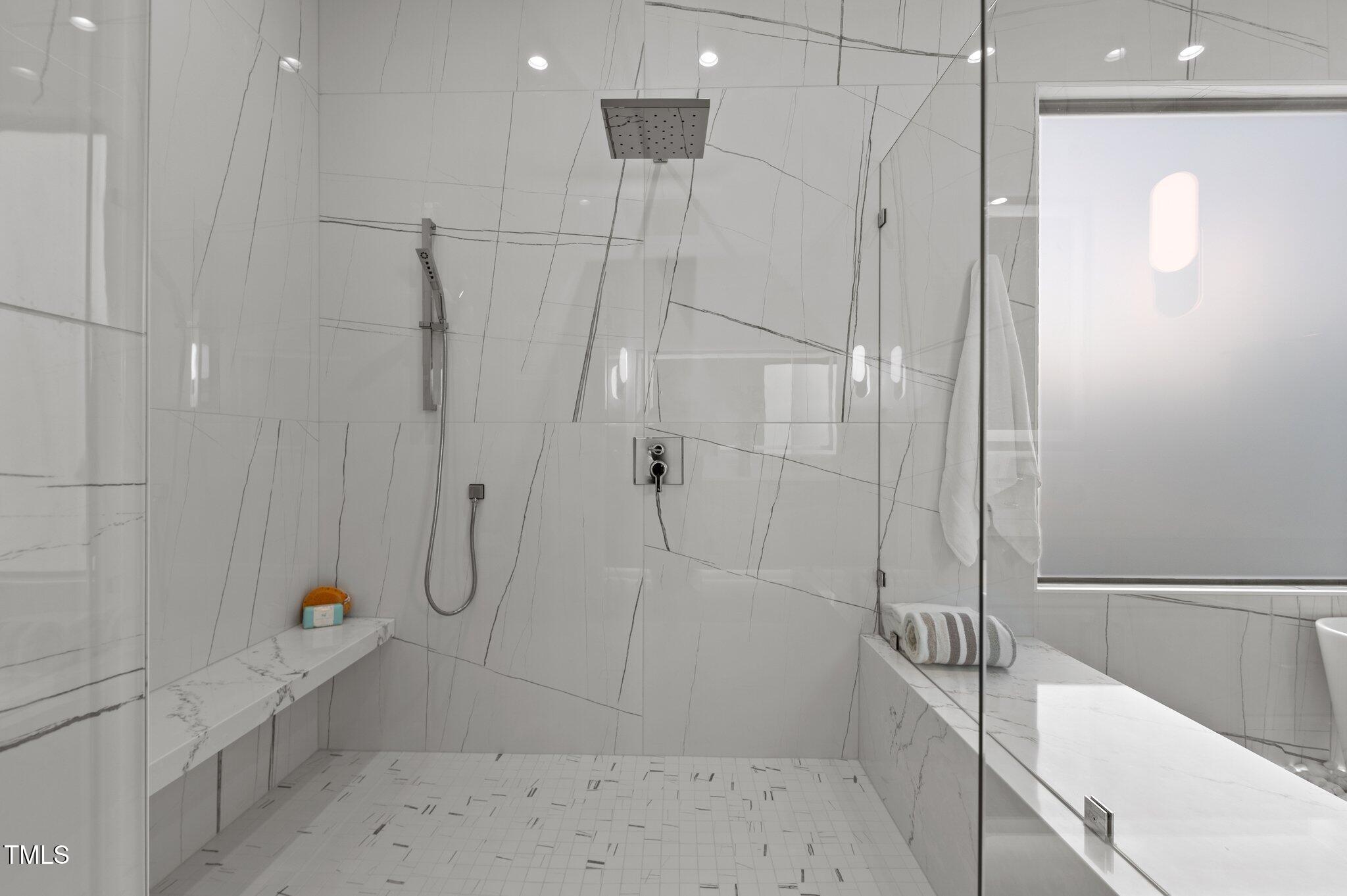 949 Harrison Ridge Road Wake Forest, NC 27587 - Photo 19 of 52 a bathroom with a bathtub and a shower