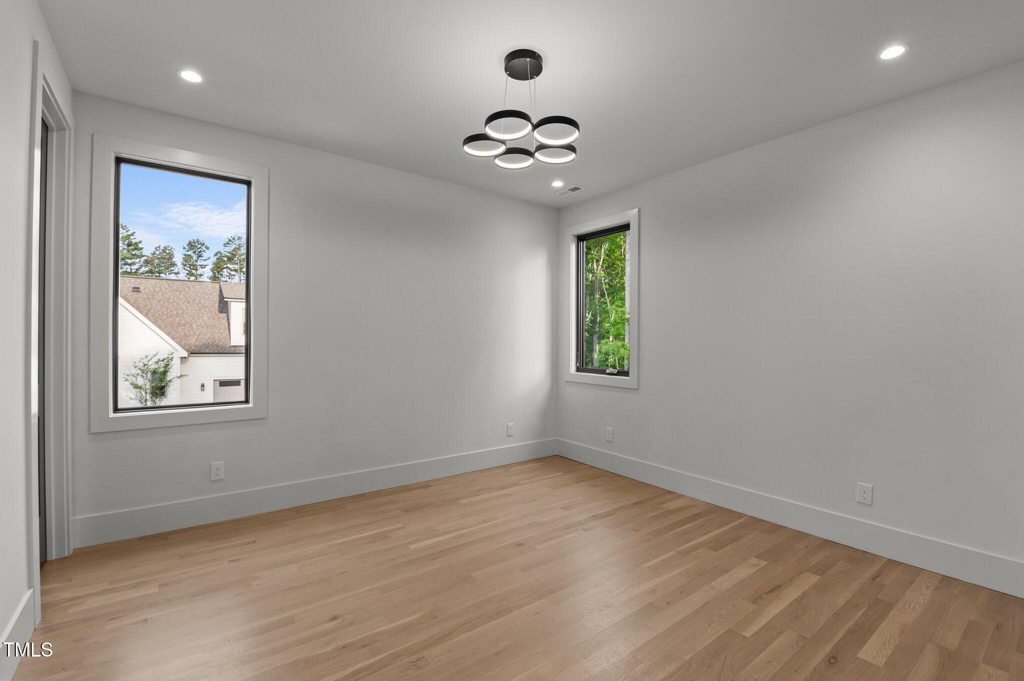 949 Harrison Ridge Road Wake Forest, NC 27587 - Photo 27 of 52 wooden floor in an empty room with a window