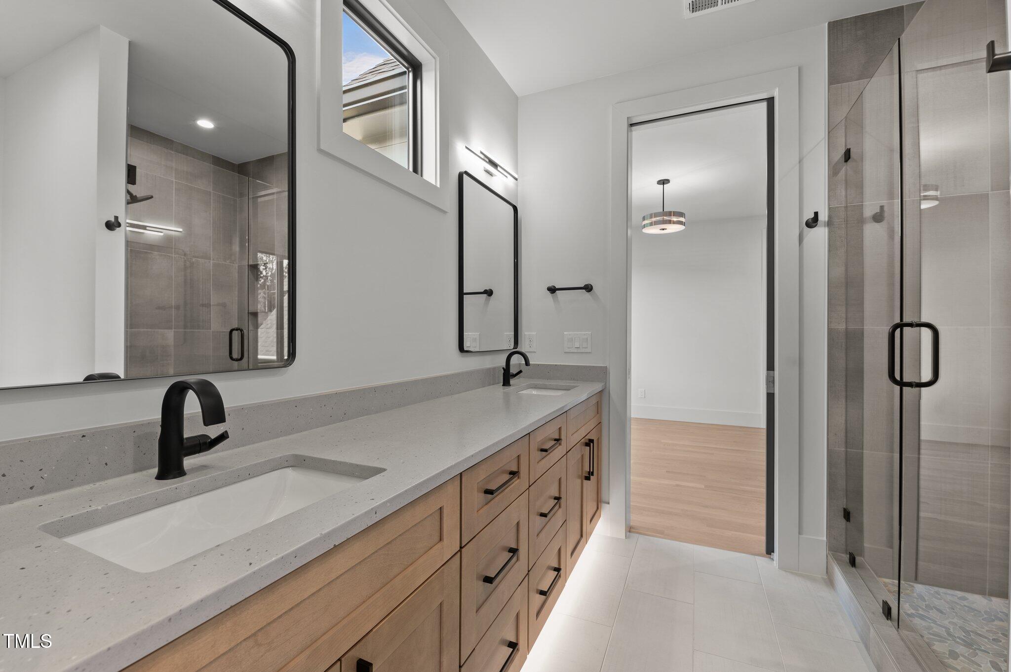 949 Harrison Ridge Road Wake Forest, NC 27587 - Photo 32 of 52 a bathroom with a double vanity sink and mirror