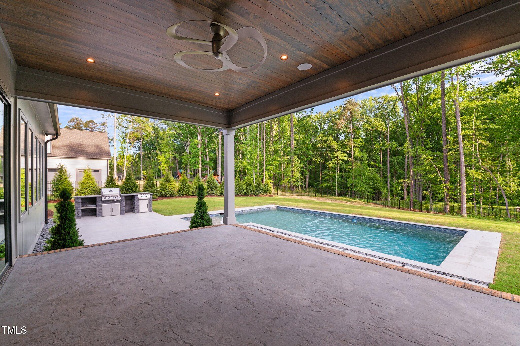 949 Harrison Ridge Road Wake Forest, NC 27587 - Photo 42 of 52 a view of a swimming pool with a big yard