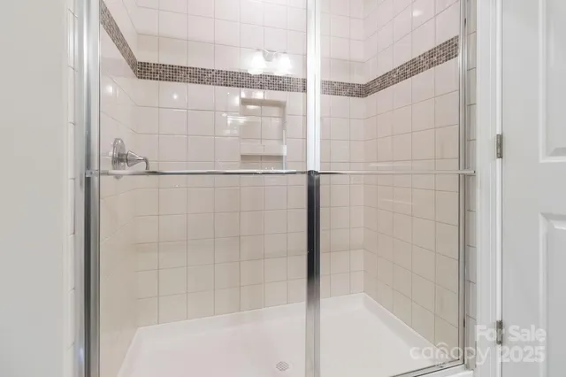 a bathroom with a glass shower door