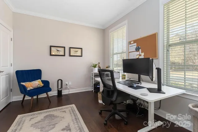 a view of a workspace with furniture and a window