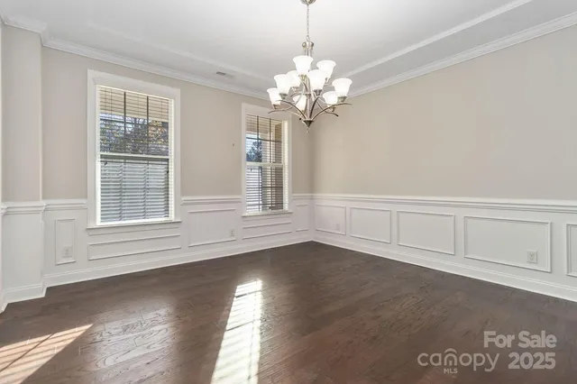 a view of wooden floor and windows in a room