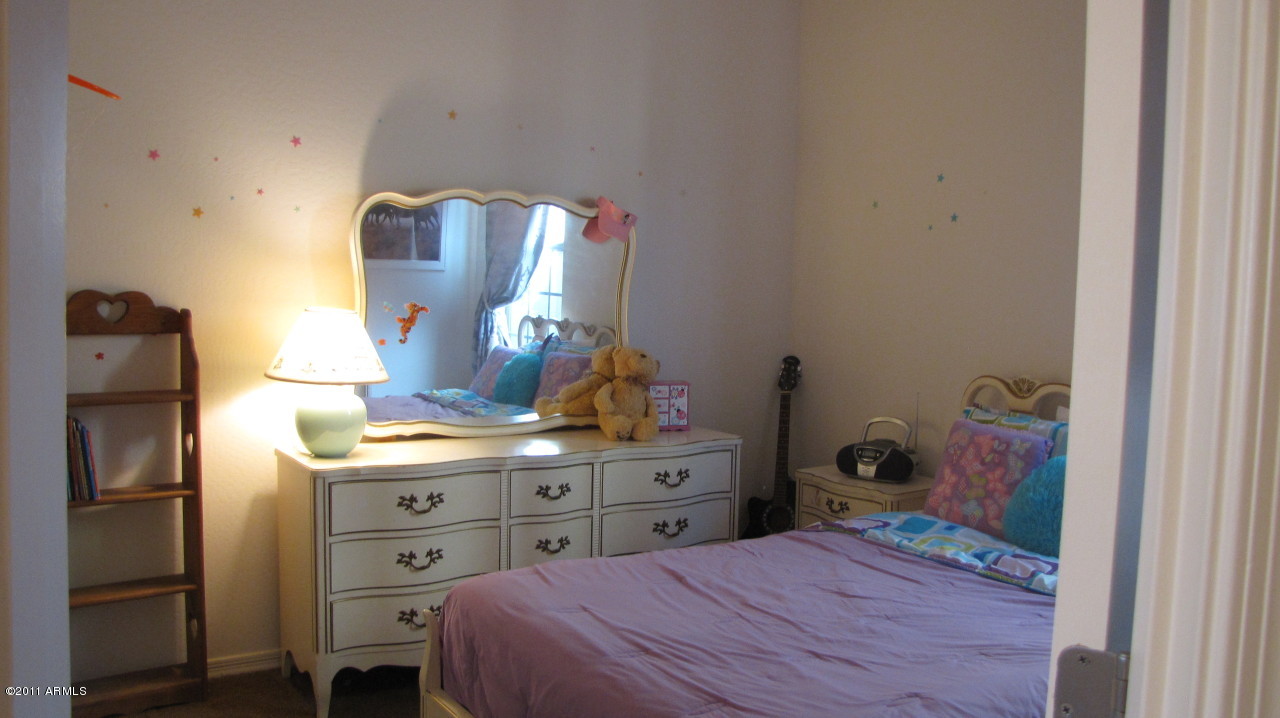 16007 West Pima Street Goodyear, AZ 85338 - Photo 13 of 35 a bedroom with a bed and wooden floor