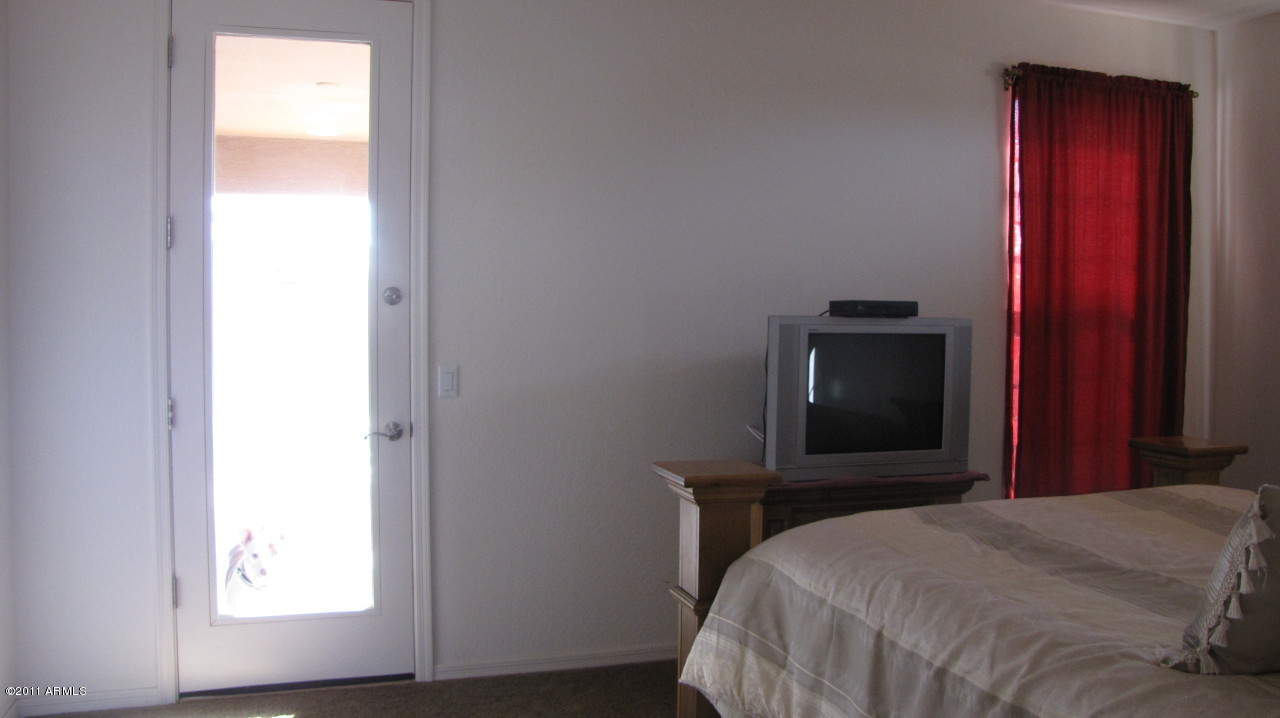 16007 West Pima Street Goodyear, AZ 85338 - Photo 20 of 35 a bedroom with a bed and a window