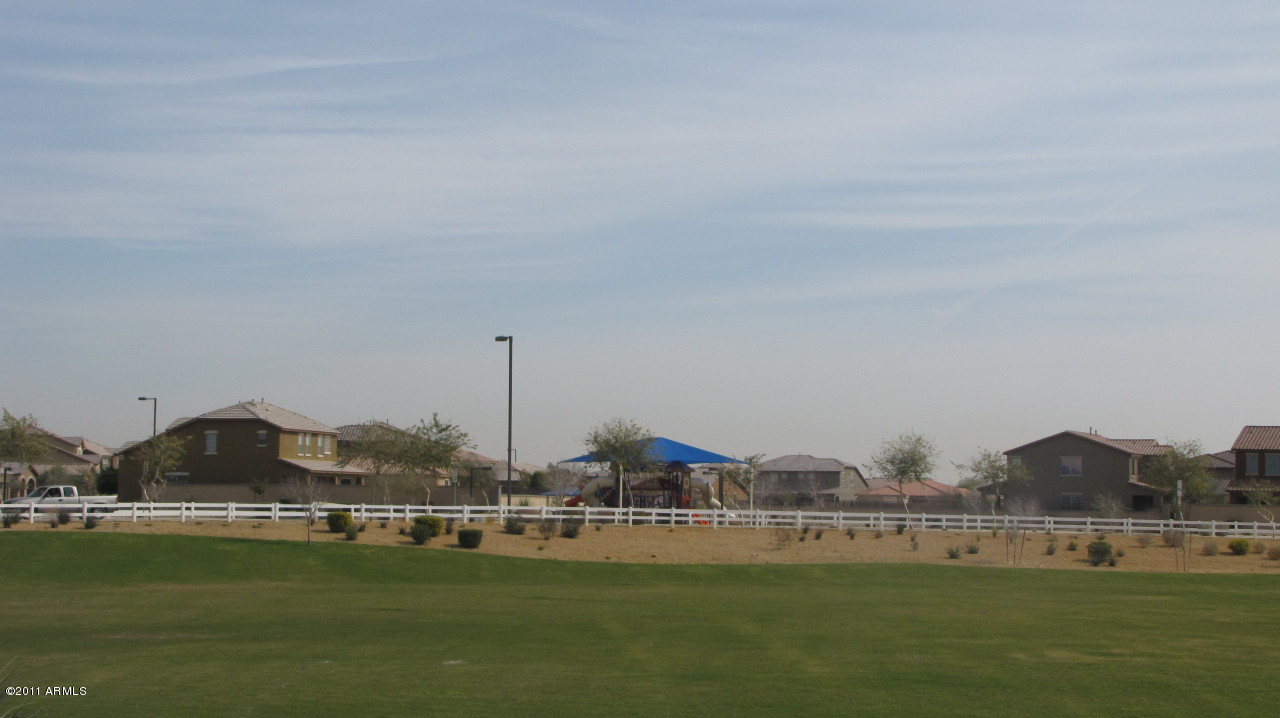 16007 West Pima Street Goodyear, AZ 85338 - Photo 29 of 35 a view of a lake with houses in the back