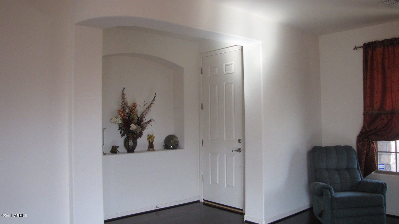 16007 West Pima Street Goodyear, AZ 85338 - Photo 3 of 35 a view of a hallway and a livingroom with furniture
