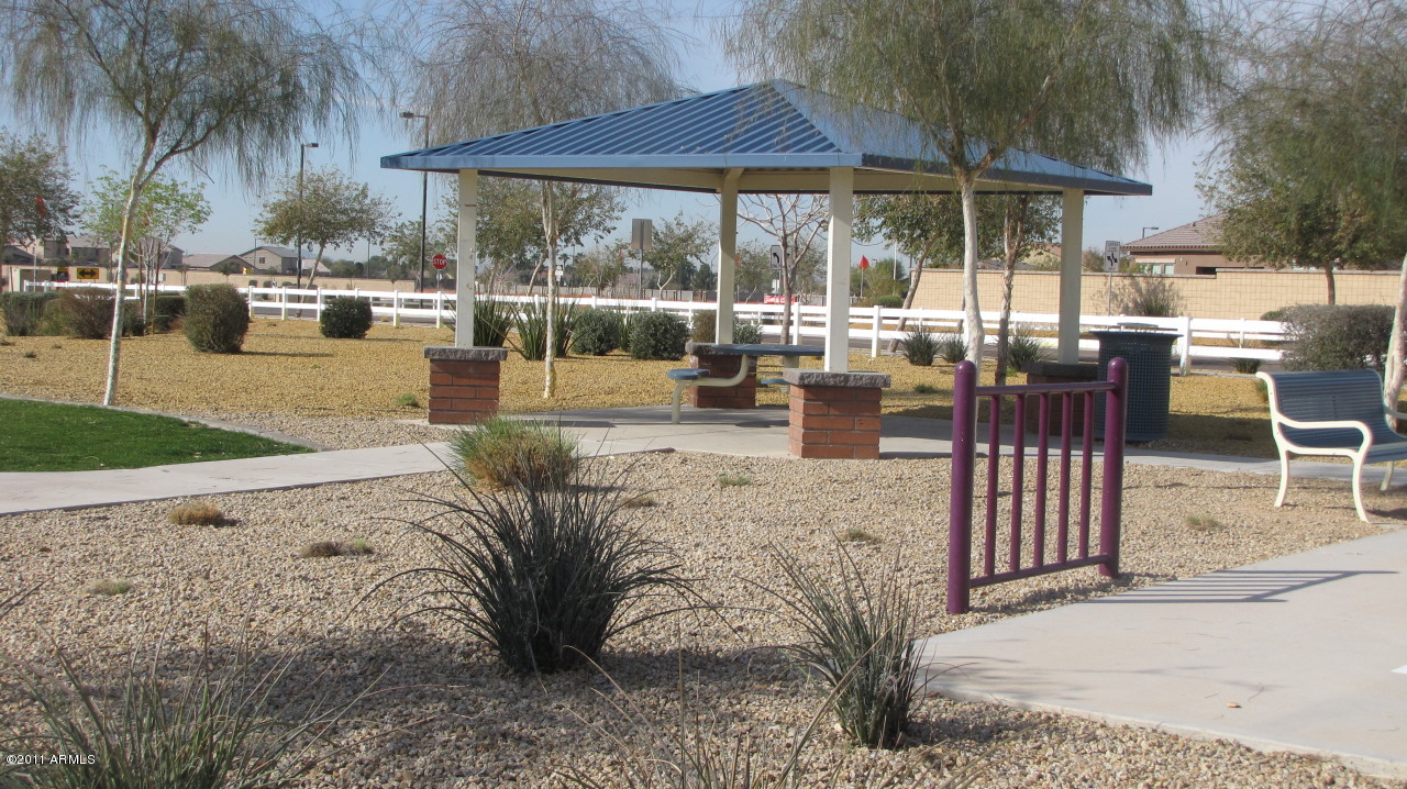 16007 West Pima Street Goodyear, AZ 85338 - Photo 31 of 35 a view of a patio with table and chairs under an umbrella