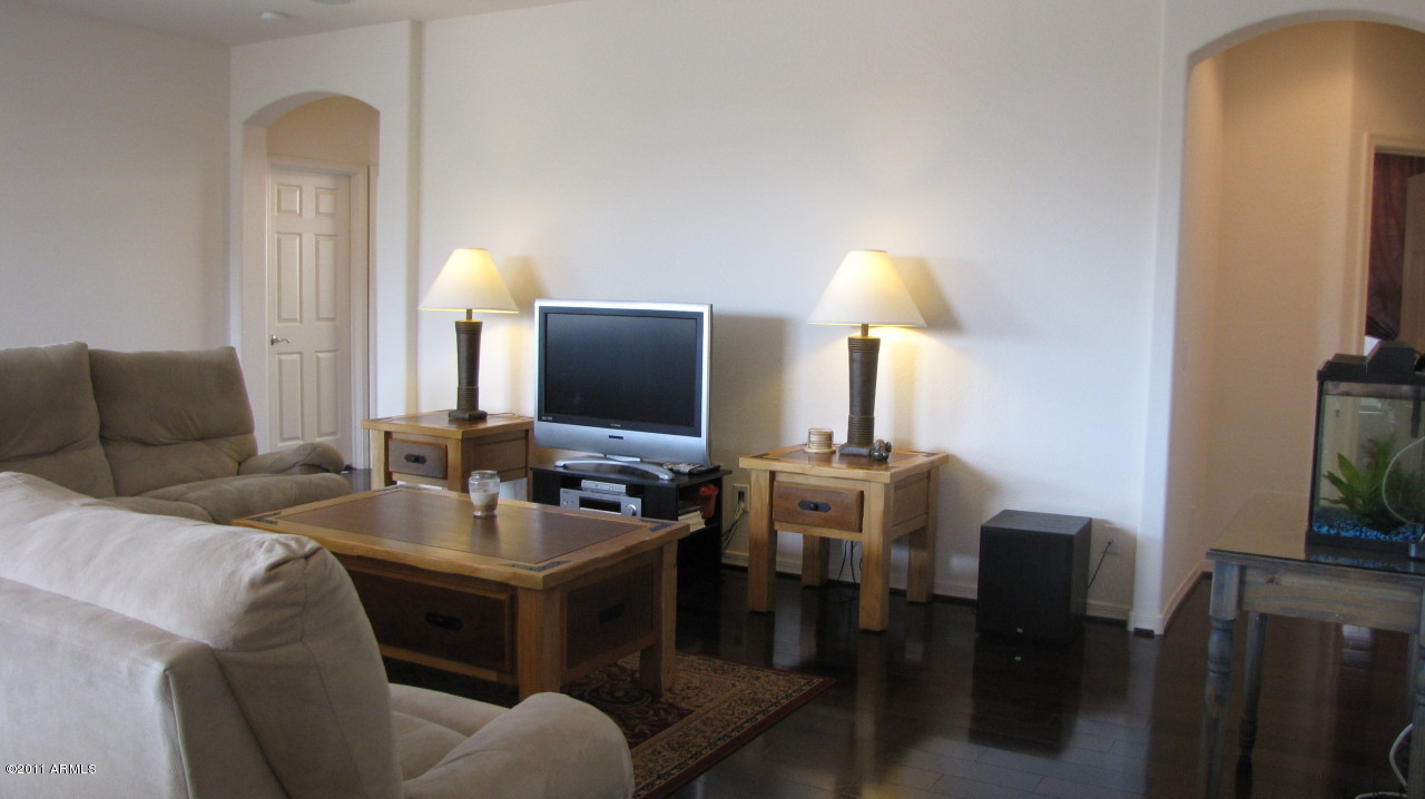16007 West Pima Street Goodyear, AZ 85338 - Photo 8 of 35 a dining room with furniture and a flat screen tv
