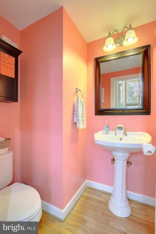 a bathroom with a sink mirror and toilet